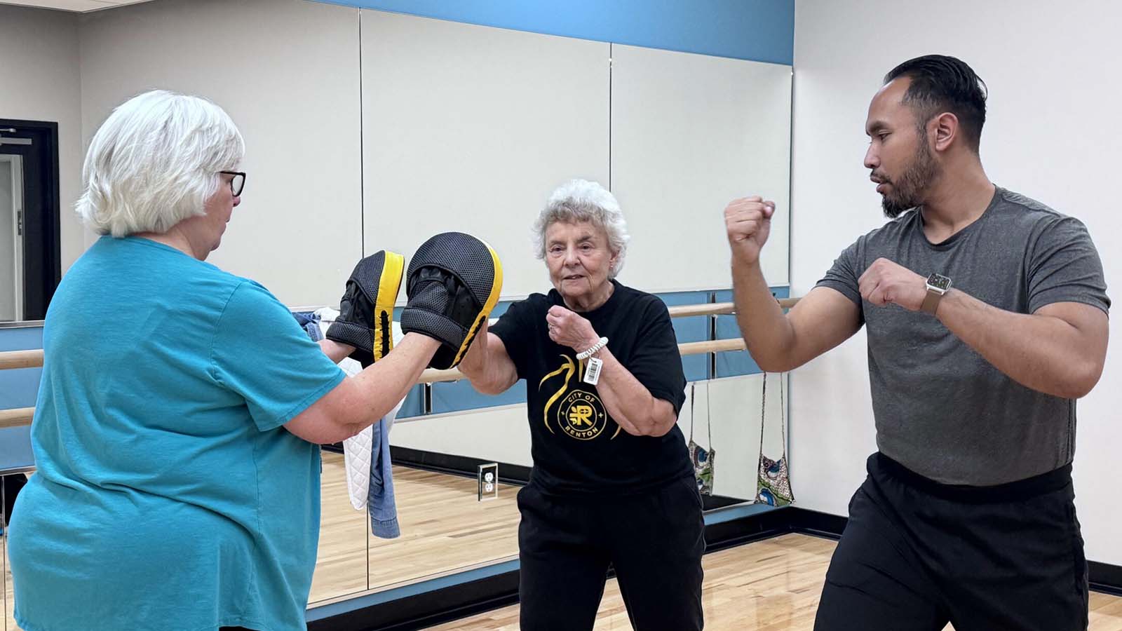 Adults practicing martial arts together