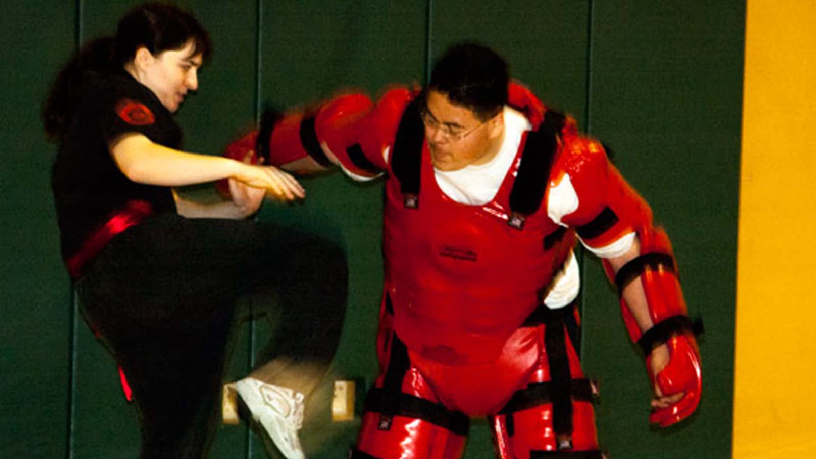 Student practicing applied technique with protective equipment